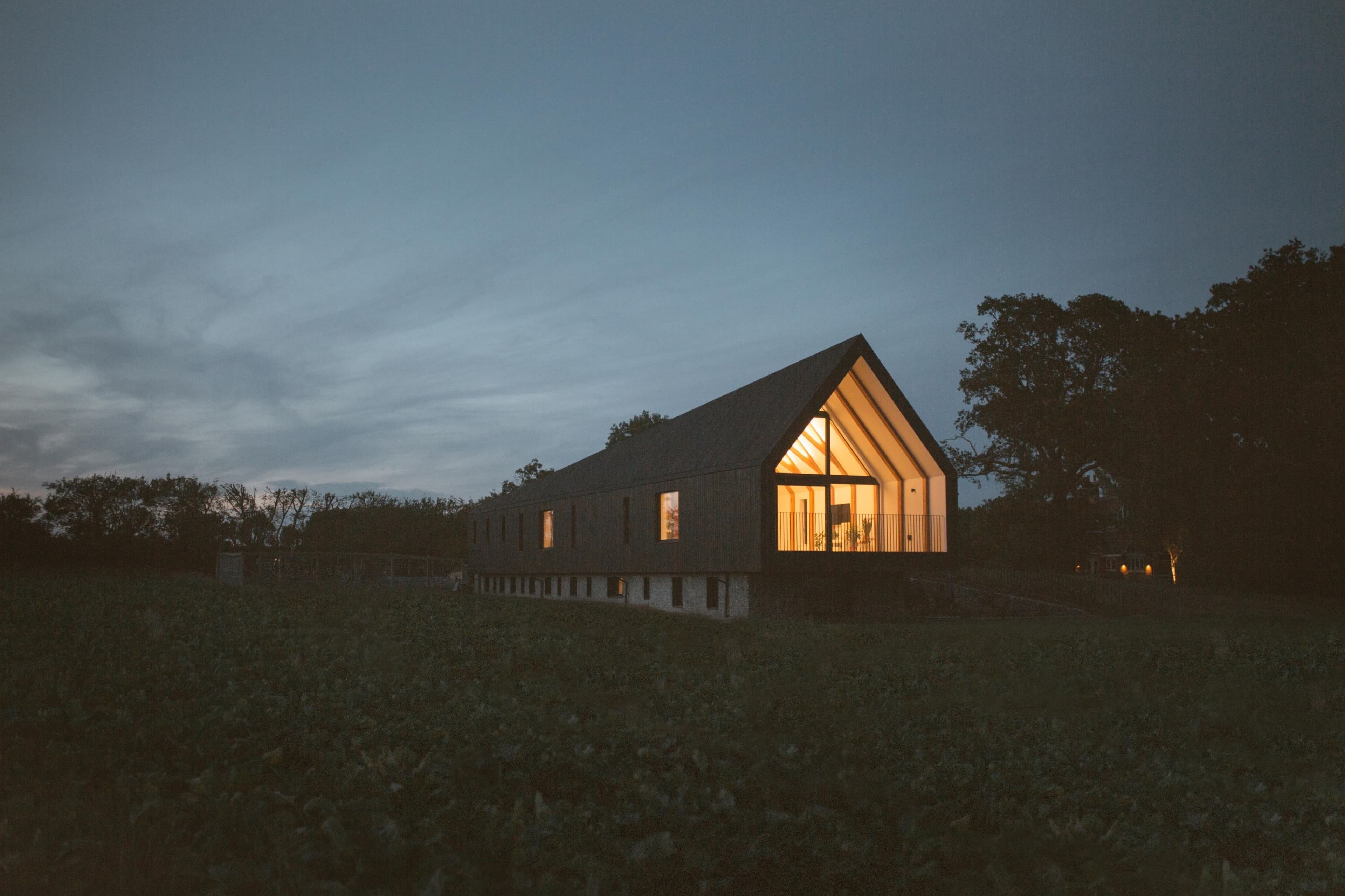 Black Barn at dusk, a contemporary barn-style Paragraph 84 home