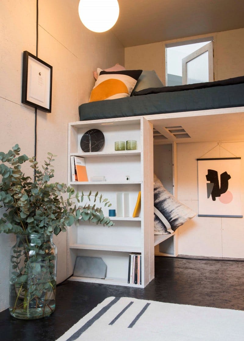 Tiny home living space with shelving by Studio Bark