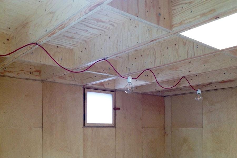Lighting wires hang inside with an exposed undulating red wire