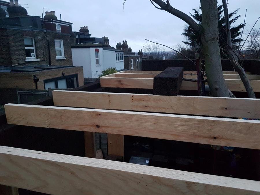 Timber roof joists set out to support the roof