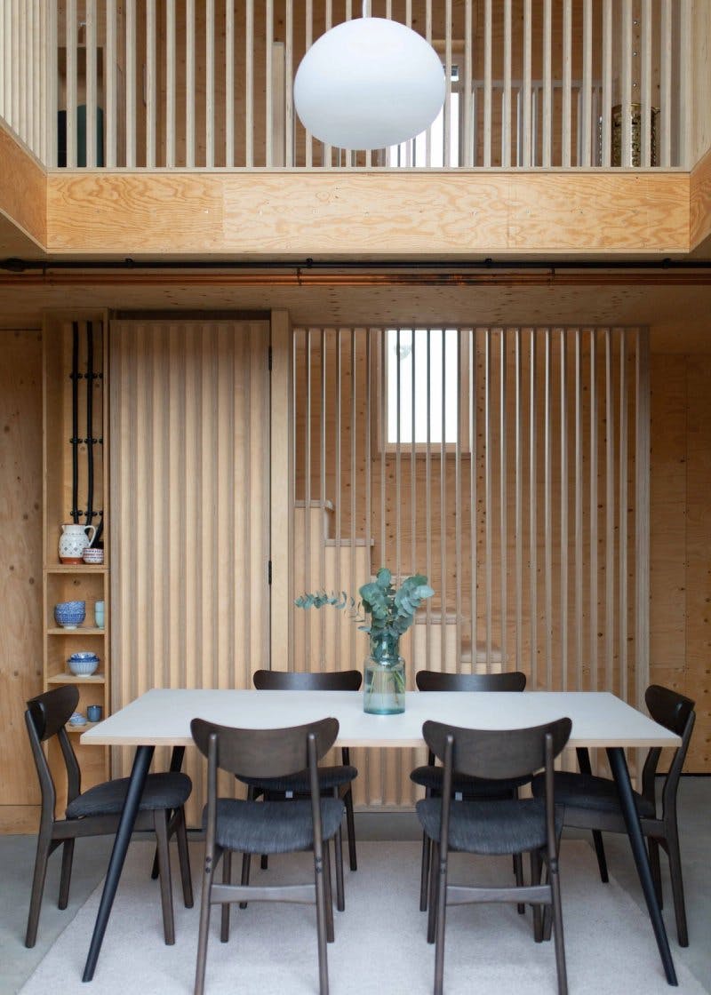 Double height dining room with timber details