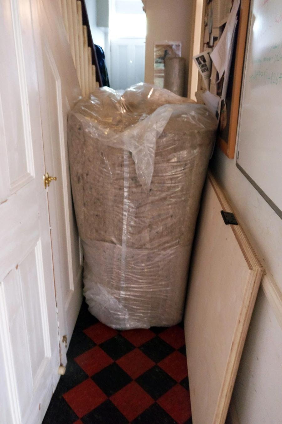 Roll of sheep's wool insulation sits within a hallway