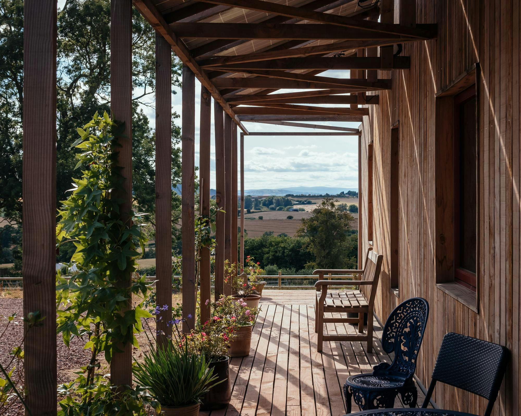 A timber terrace at Nest House overlooking the countryside