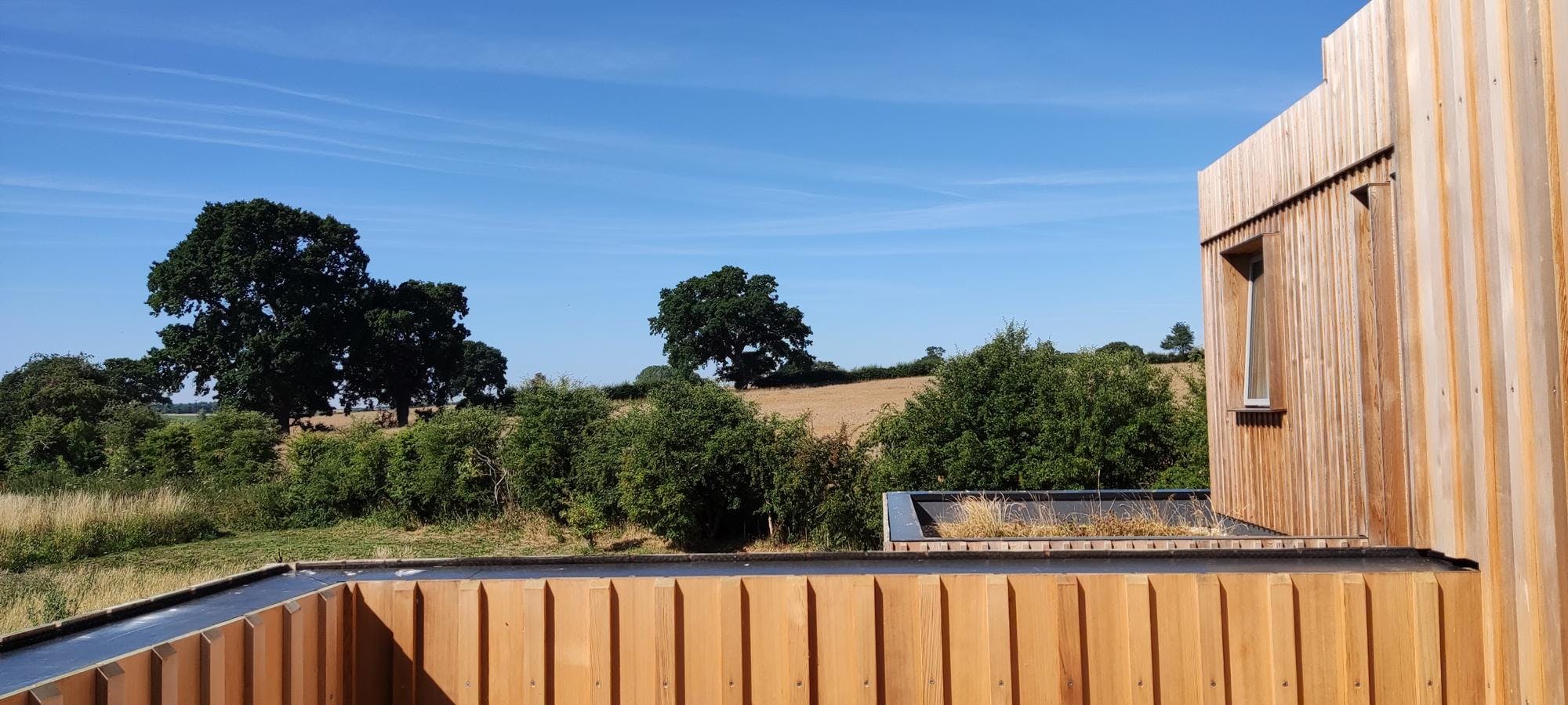 View from greenroof of timber clad Paragraph 80 home overlooking hills